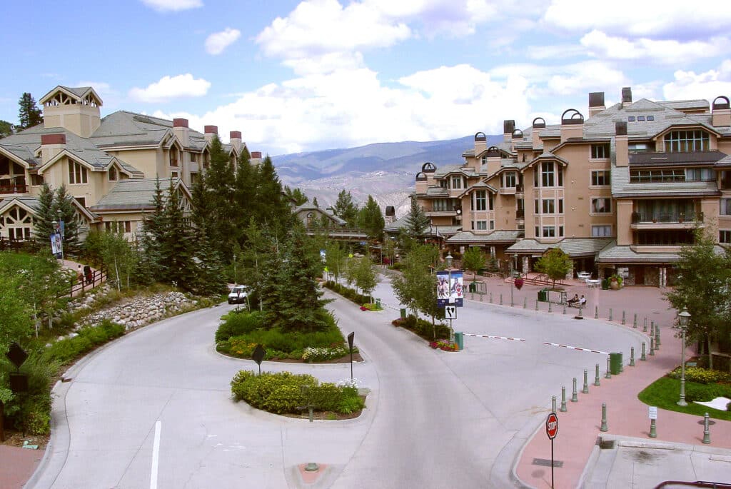 a street with trees and buildings in the background